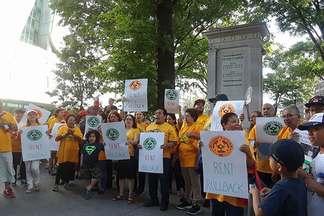 Tenants rally for rent freezes and rent roll-backs before the meeting